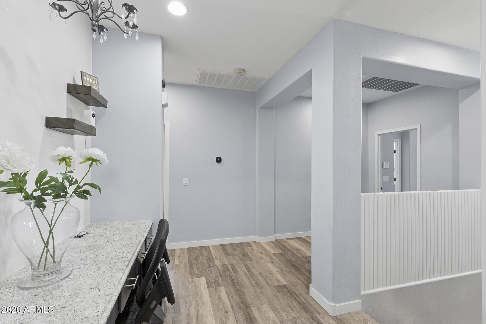 6848 West Ridgeline Road Peoria, AZ 85383 - Photo 35 of 71 a view of a hallway with wooden floor and a potted plant