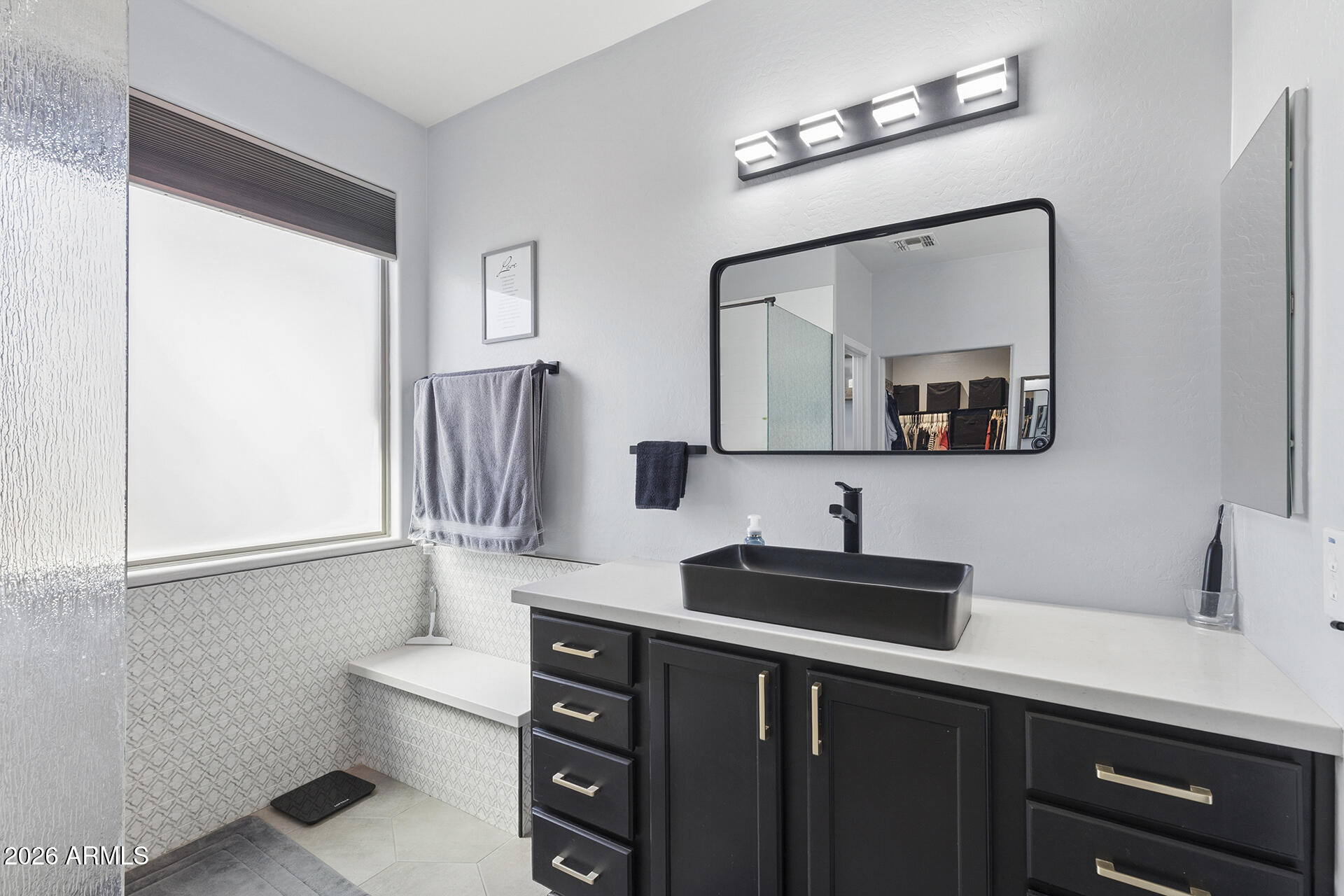 6848 West Ridgeline Road Peoria, AZ 85383 - Photo 55 of 71 a bathroom with a sink a toilet and mirror