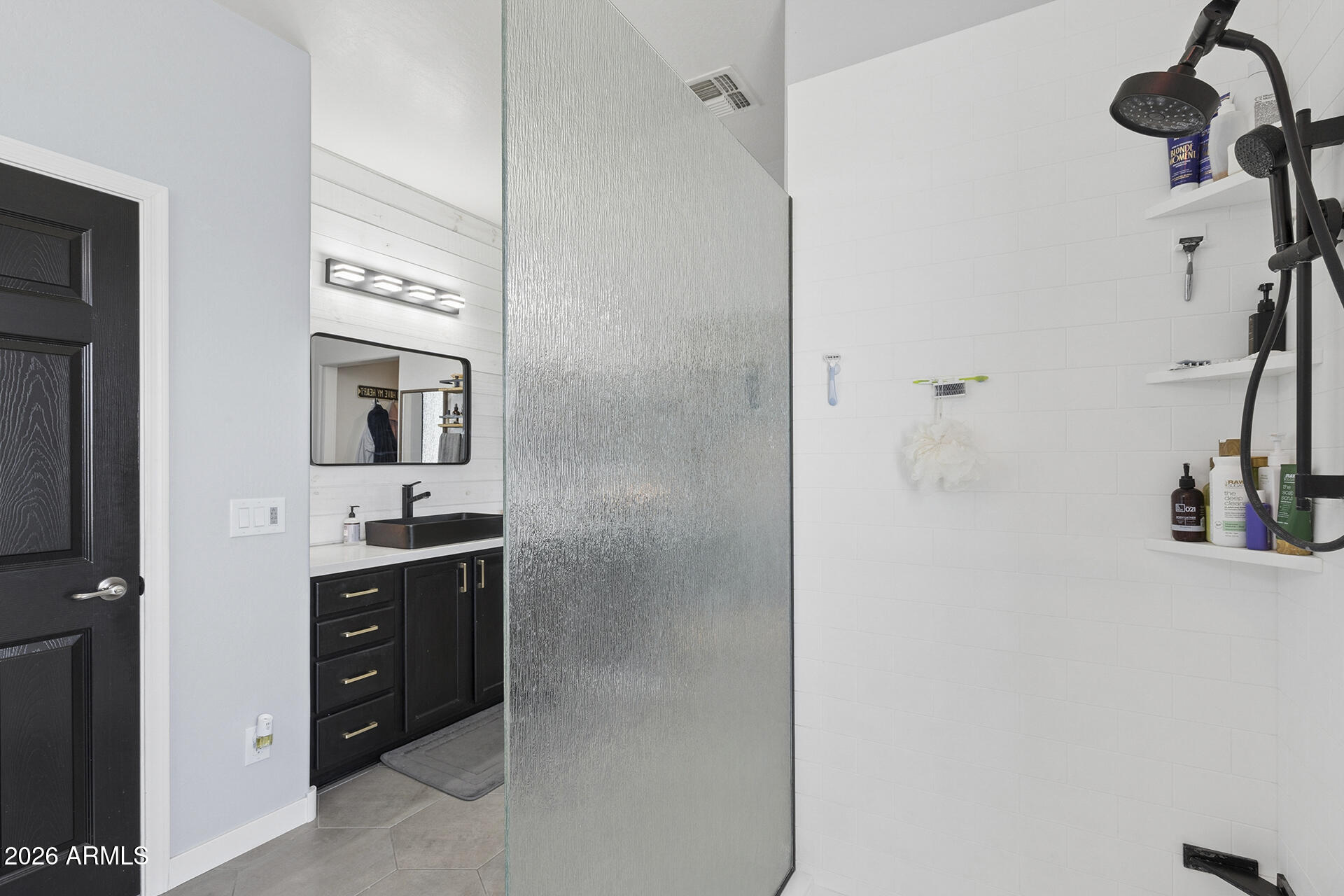 6848 West Ridgeline Road Peoria, AZ 85383 - Photo 57 of 71 a bathroom with a granite countertop sink a mirror and shower