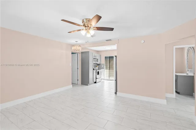 a view of a livingroom with a ceiling fan and window