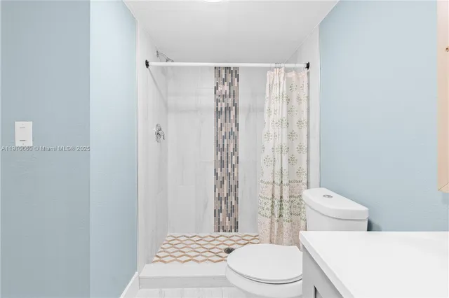 a white toilet sitting next to a bathroom sink