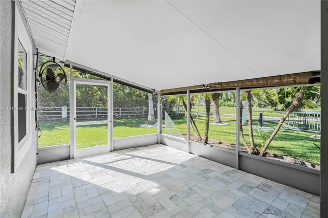 a view of an empty room with a large windows