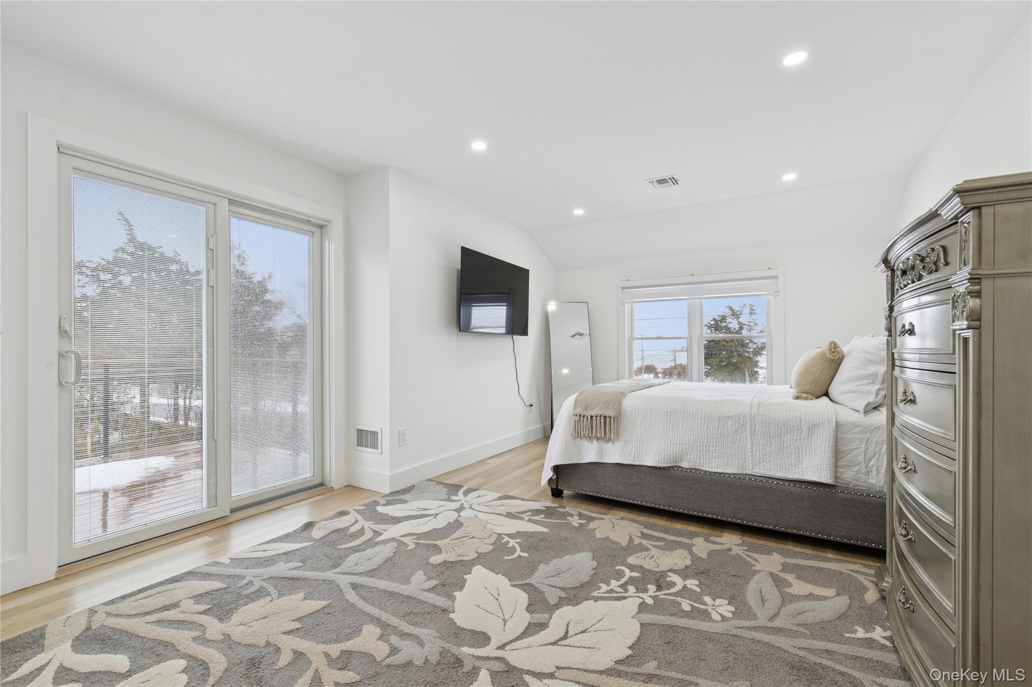 10 Sagamore Road Hampton Bays, NY 11946 - Photo 29 of 41 a bedroom with a large bed and a flat tv screen