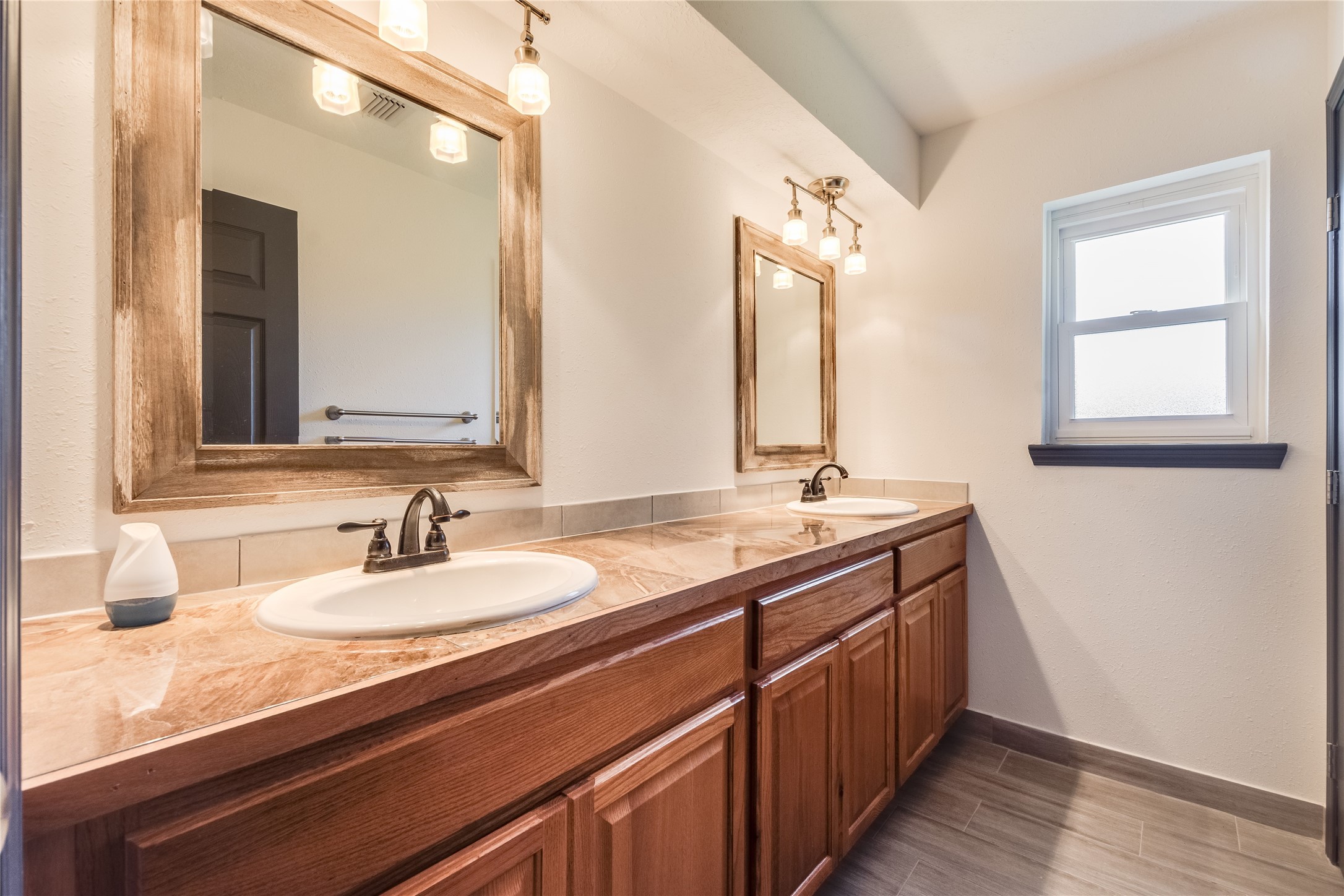 2004 Sleepy Hollow Drive Pearland, TX 77581 - Photo 11 of 13 a bathroom with a sink double vanity and a mirror