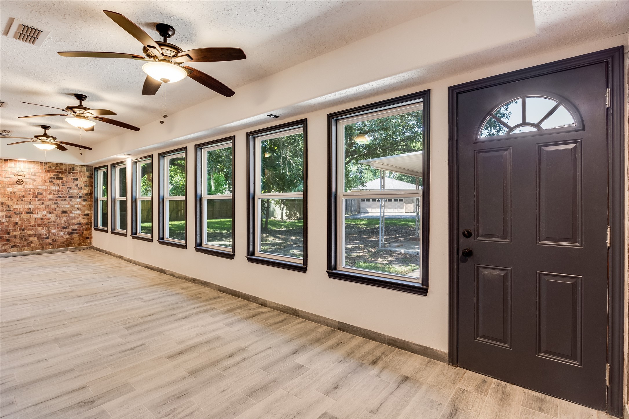 2004 Sleepy Hollow Drive Pearland, TX 77581 - Photo 12 of 13 a view of an empty room with a window and wooden floor