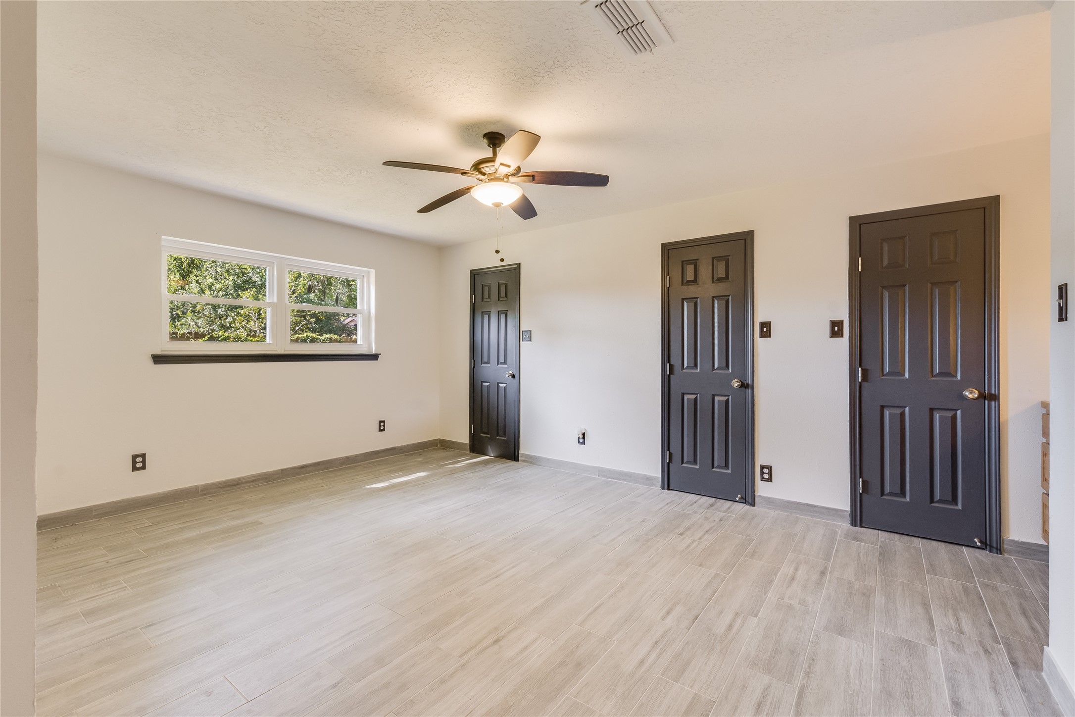 2004 Sleepy Hollow Drive Pearland, TX 77581 - Photo 10 of 13 a view of empty room with wooden floor and ceiling fan