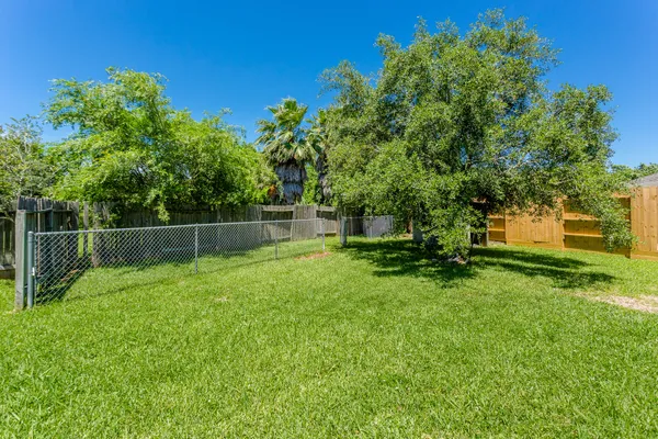 a view of a yard with a fence