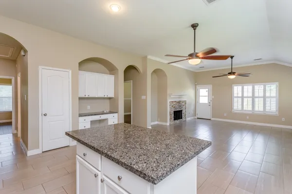 a view of living room with granite countertop furniture and fireplace