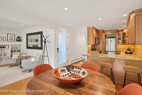 a living room with furniture and a dining table