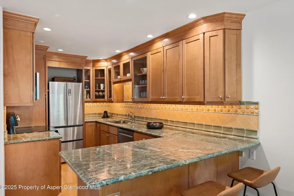 a kitchen with a sink a stove and a refrigerator