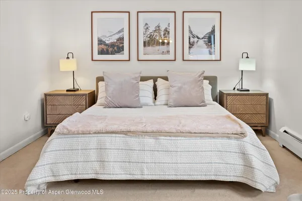 a bedroom with a bed and lamp