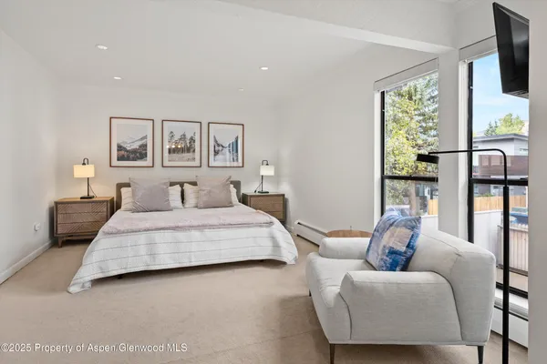 a bedroom with a large bed and a couch