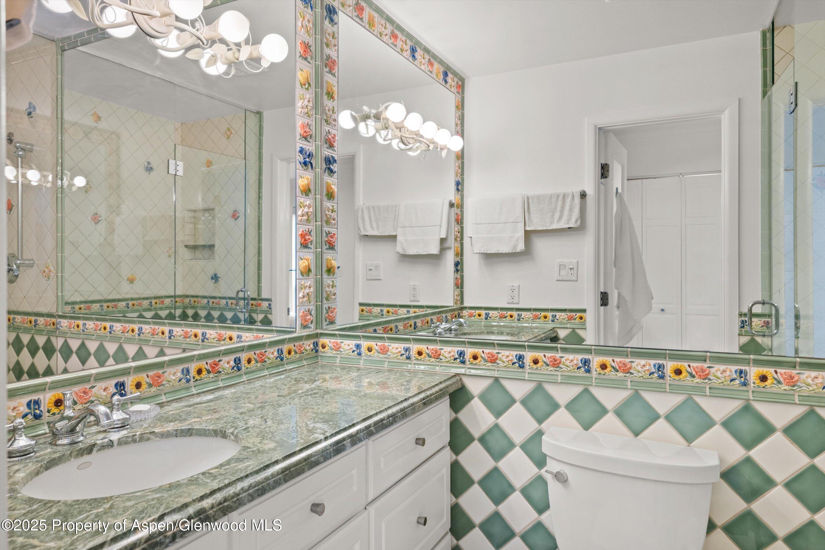 980 East Hyman Avenue, Unit 3 Aspen, CO 81611 - Photo 21 of 26 a bathroom with a granite countertop sink a mirror a and a shower
