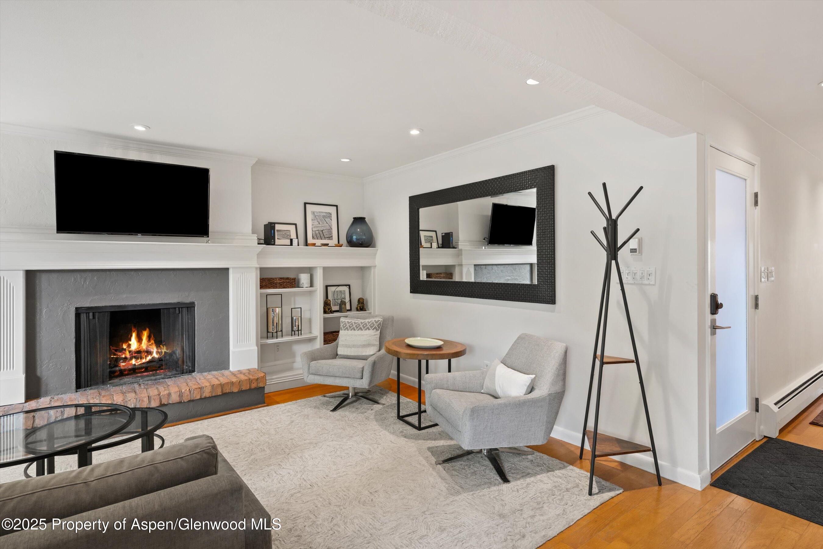 980 East Hyman Avenue, Unit 3 Aspen, CO 81611 - Photo 4 of 26 a living room with furniture and a fireplace