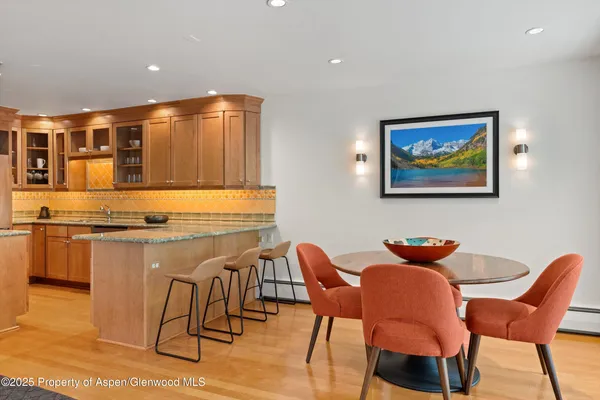 a kitchen with stainless steel appliances kitchen island granite countertop furniture and a view of living room