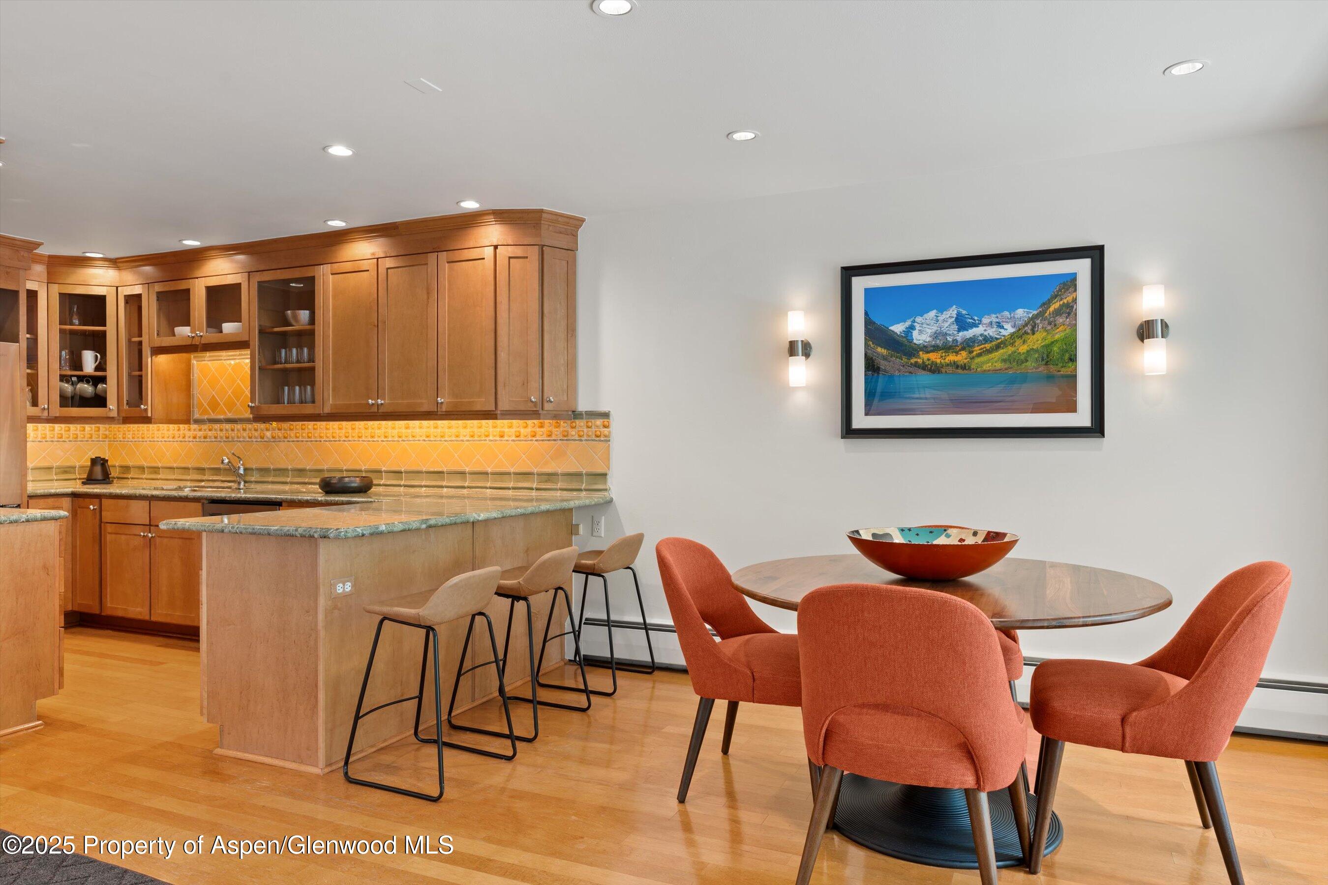 980 East Hyman Avenue, Unit 3 Aspen, CO 81611 - Photo 8 of 26 a kitchen with stainless steel appliances kitchen island granite countertop furniture and a view of living room