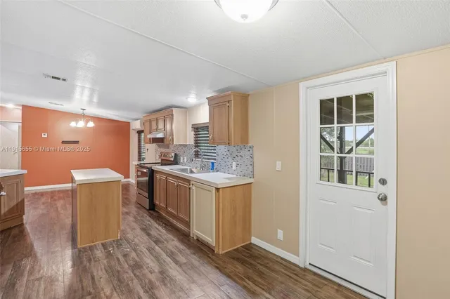 a kitchen with a stove and wooden cabinets