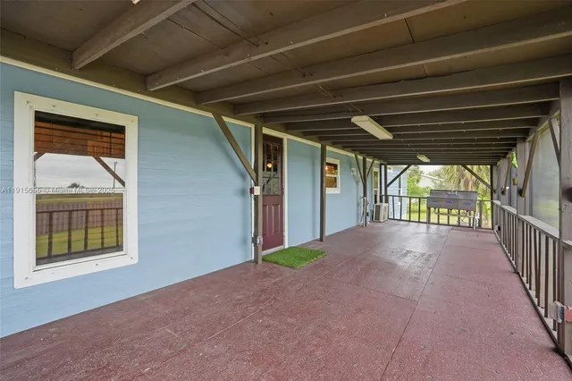 a view of a hallway with wooden floor and fence