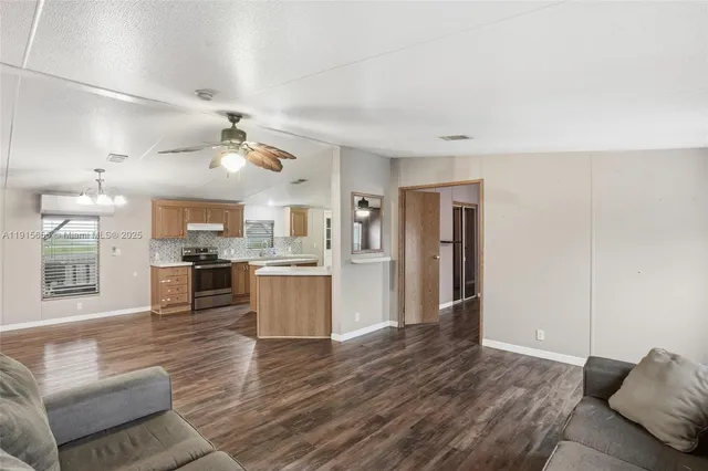 a open kitchen with white cabinets and stainless steel appliances
