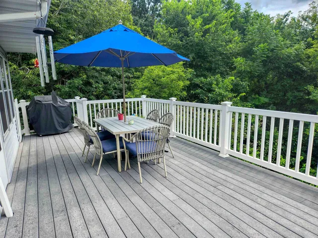 a view of a wooden deck with furniture