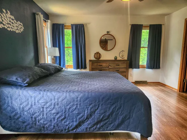 a bedroom with a bed and a window