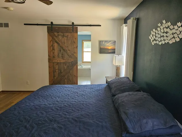 a bedroom with a bed and a dresser