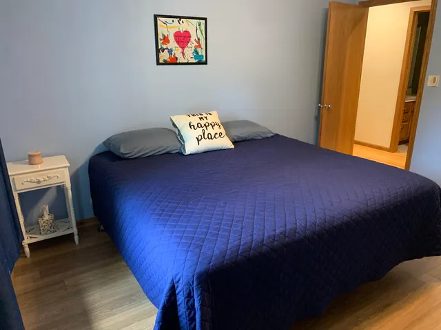 a bed sitting in a bedroom next to a window