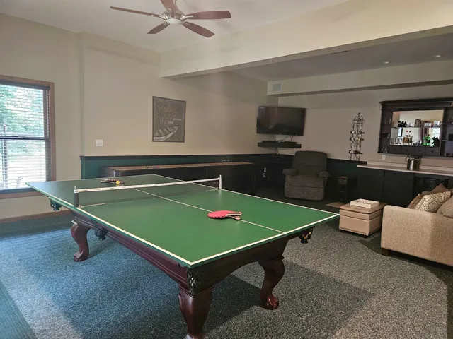 a room with pool table and windows