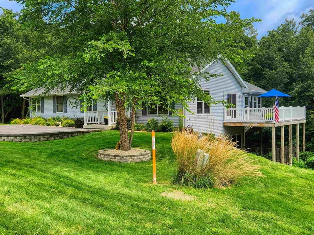 a front view of a house with a yard table and chairs