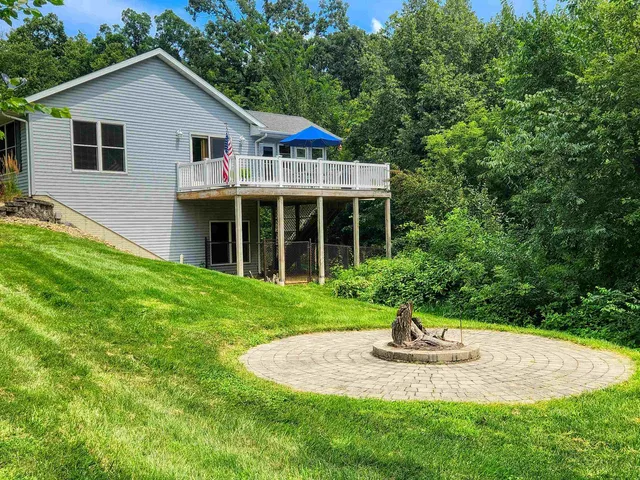 a front view of a house with a yard and trees