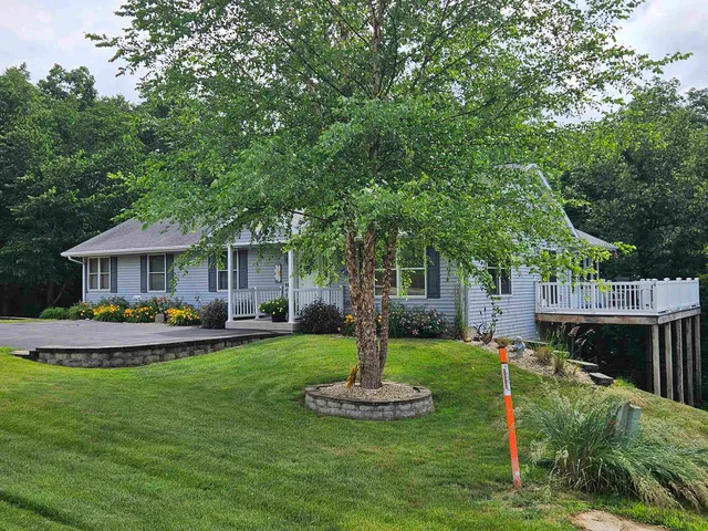 a backyard of a house with lots of green space