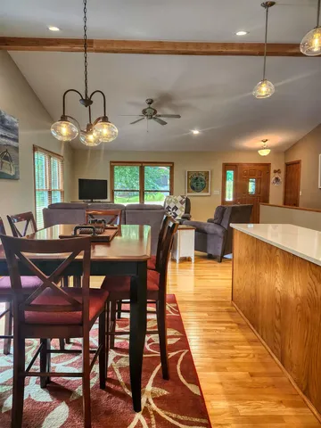 a view of a dining room with furniture and wooden floor