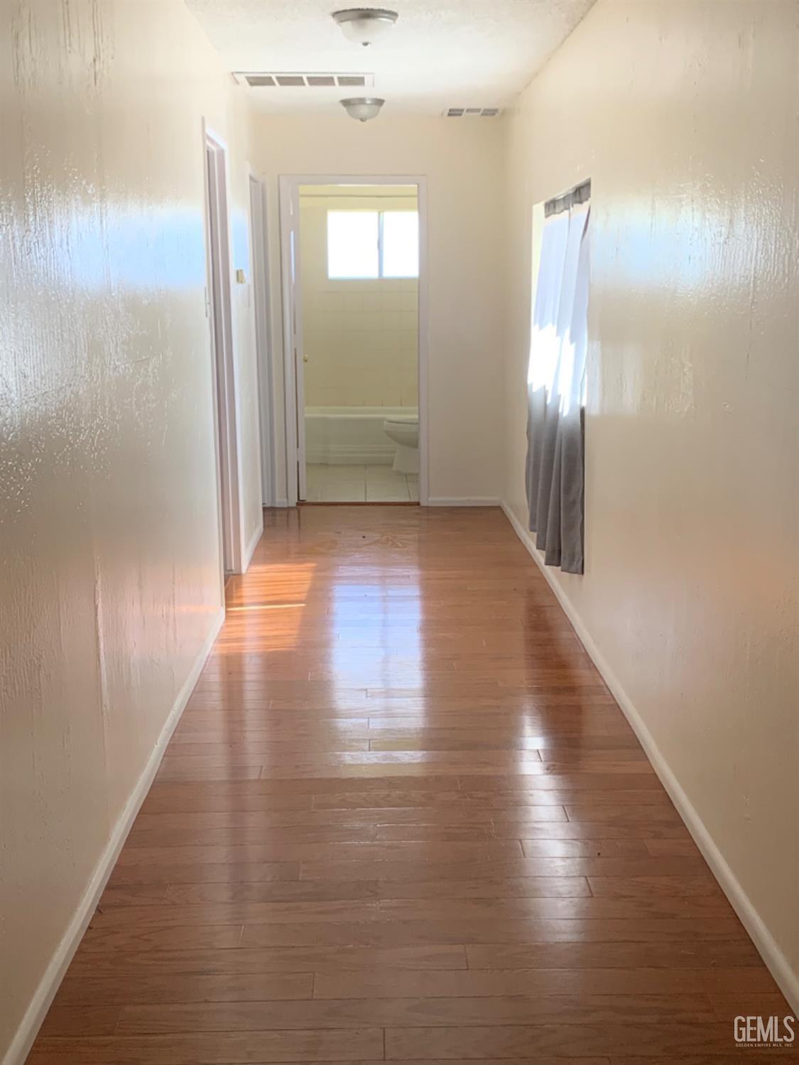 Undisclosed Address Bakersfield, CA 93306 - Photo 13 of 18 a view of a room with wooden floor