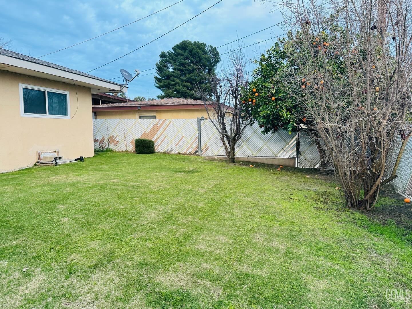 Undisclosed Address Bakersfield, CA 93306 - Photo 17 of 18 a view of a backyard with a large tree