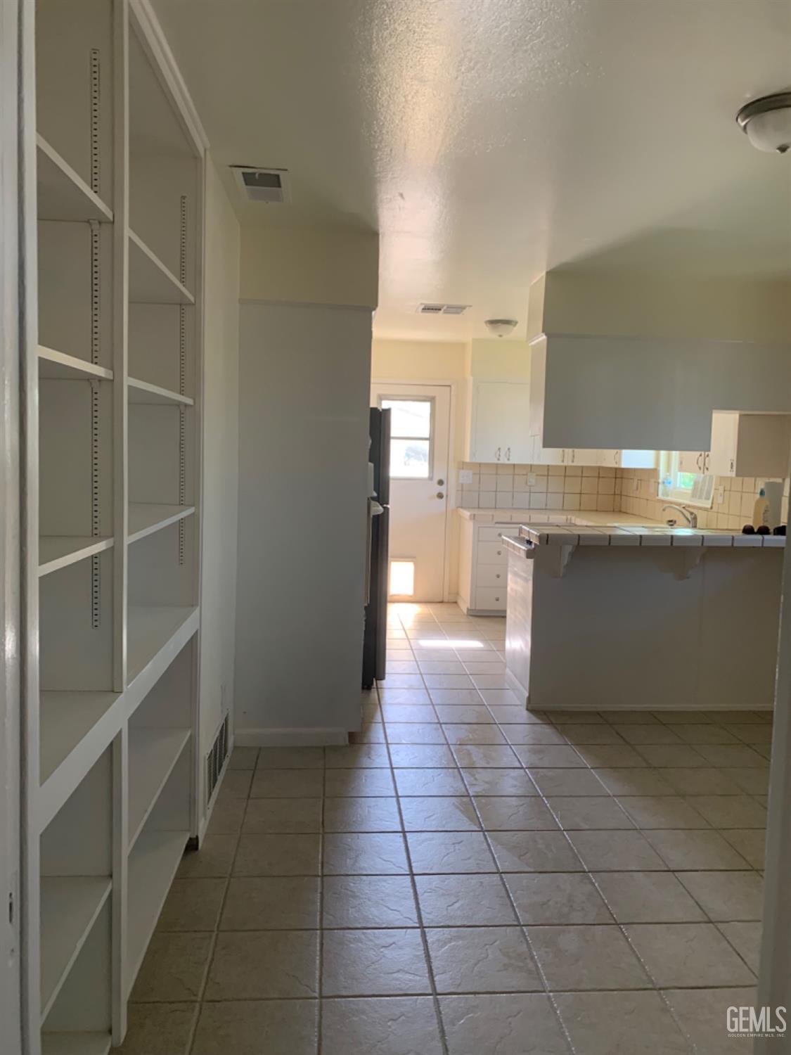 Undisclosed Address Bakersfield, CA 93306 - Photo 10 of 18 a kitchen with stainless steel appliances a sink and cabinets