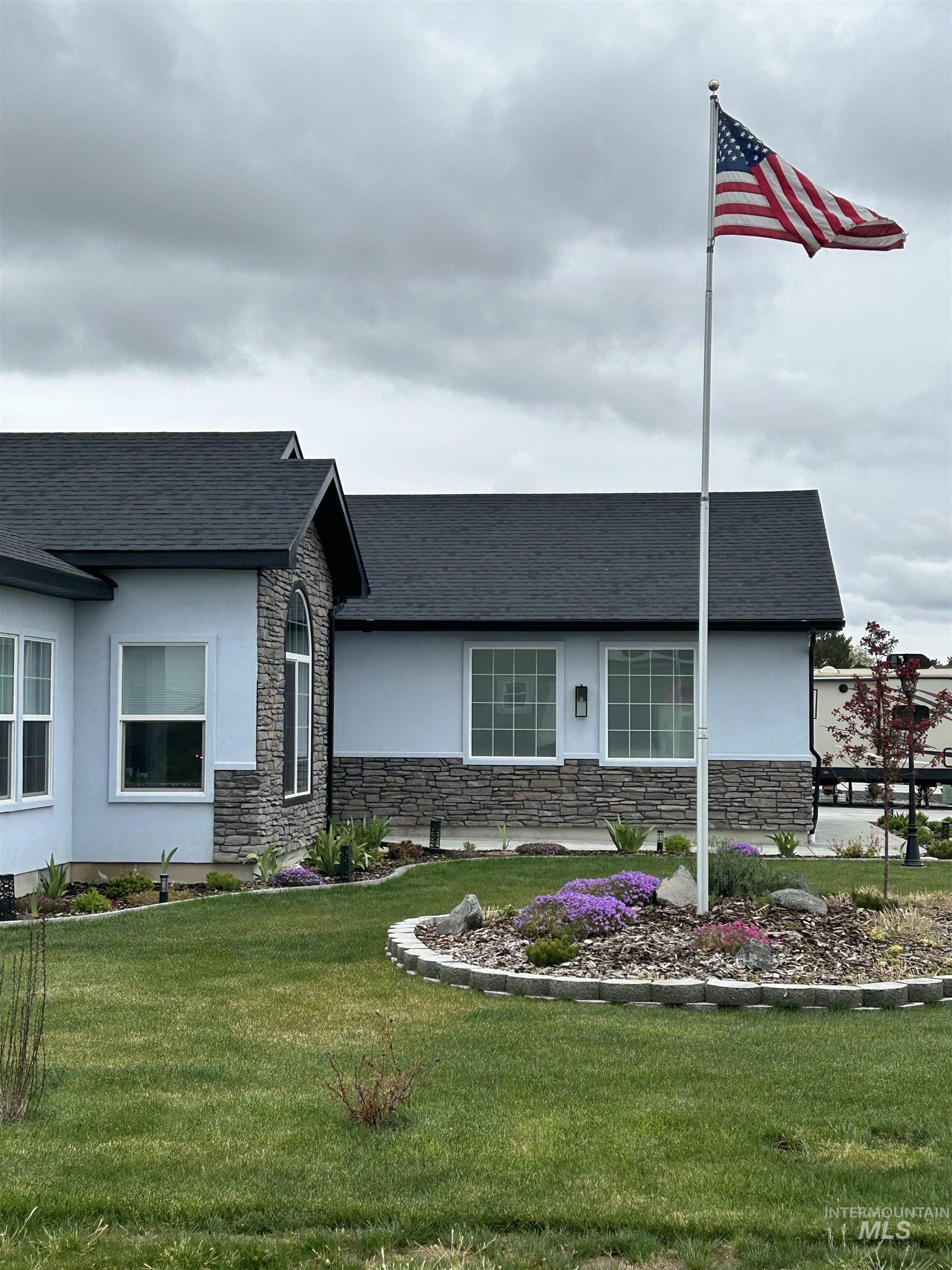 764 Heidi Terrace Kimberly, ID 83341 - Photo 19 of 42 View of front of home with stone siding, stucco siding, a front yard, and a shingled roof