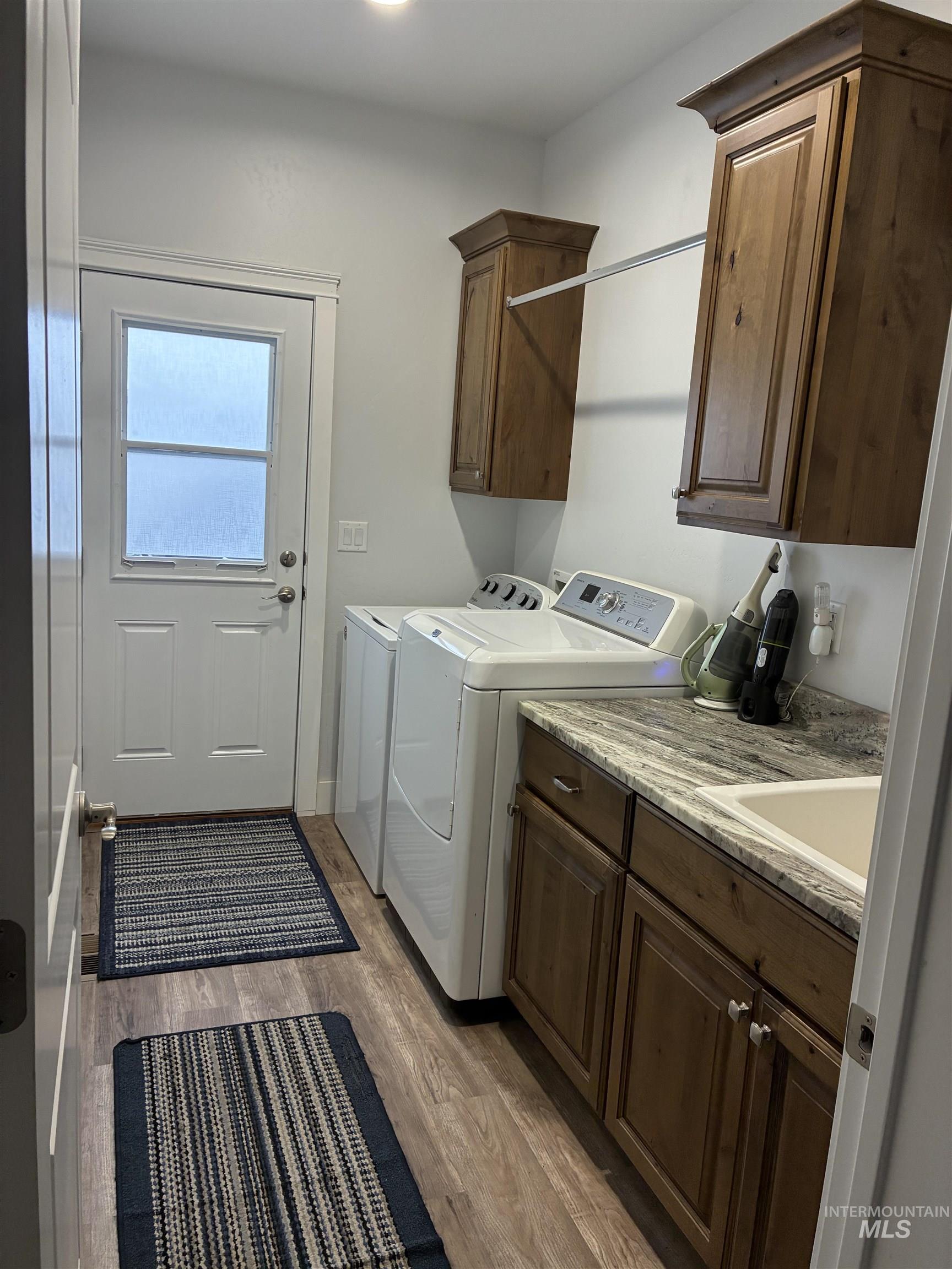 764 Heidi Terrace Kimberly, ID 83341 - Photo 27 of 42 Washroom featuring separate washer and dryer, light wood finished floors, and cabinet space