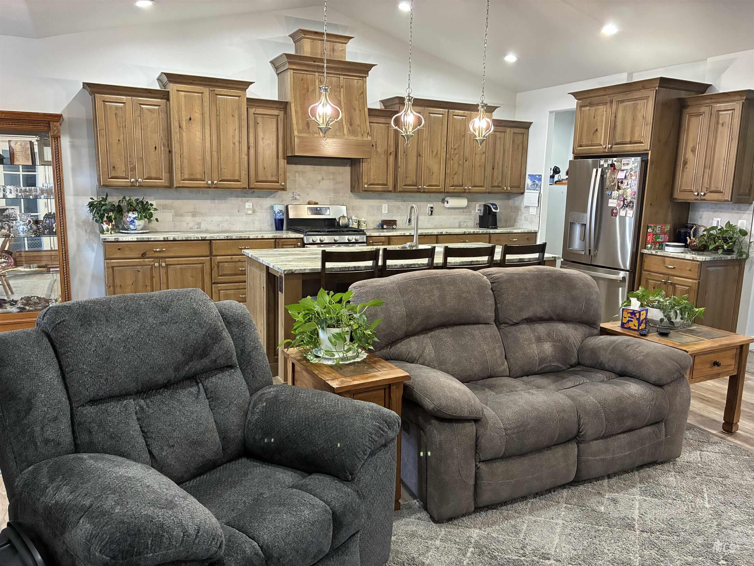 764 Heidi Terrace Kimberly, ID 83341 - Photo 42 of 42 Kitchen featuring open floor plan, decorative backsplash, brown cabinetry, a center island with sink, and recessed lighting