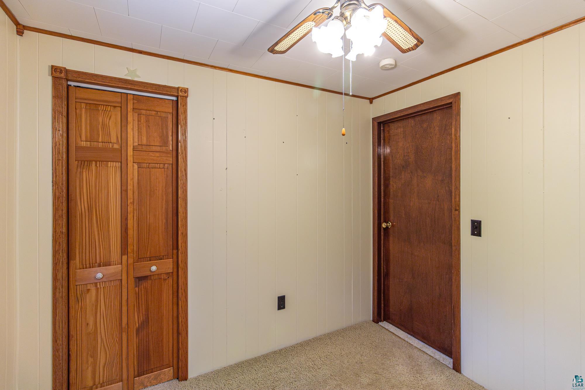 1775 Lookout Road Ely, MN 55731 - Photo 23 of 44 Unfurnished bedroom with ceiling fan and light colored carpet