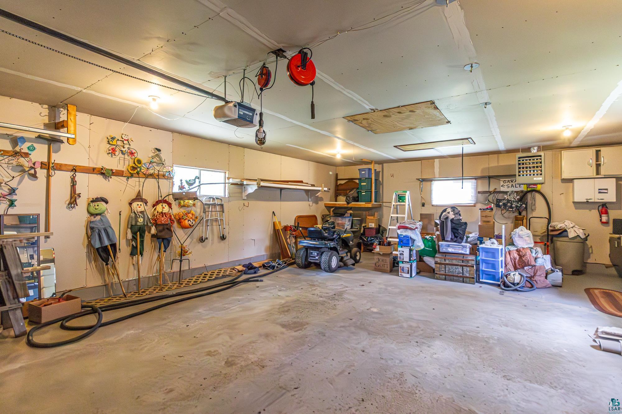 1775 Lookout Road Ely, MN 55731 - Photo 39 of 44 Garage featuring a garage door opener