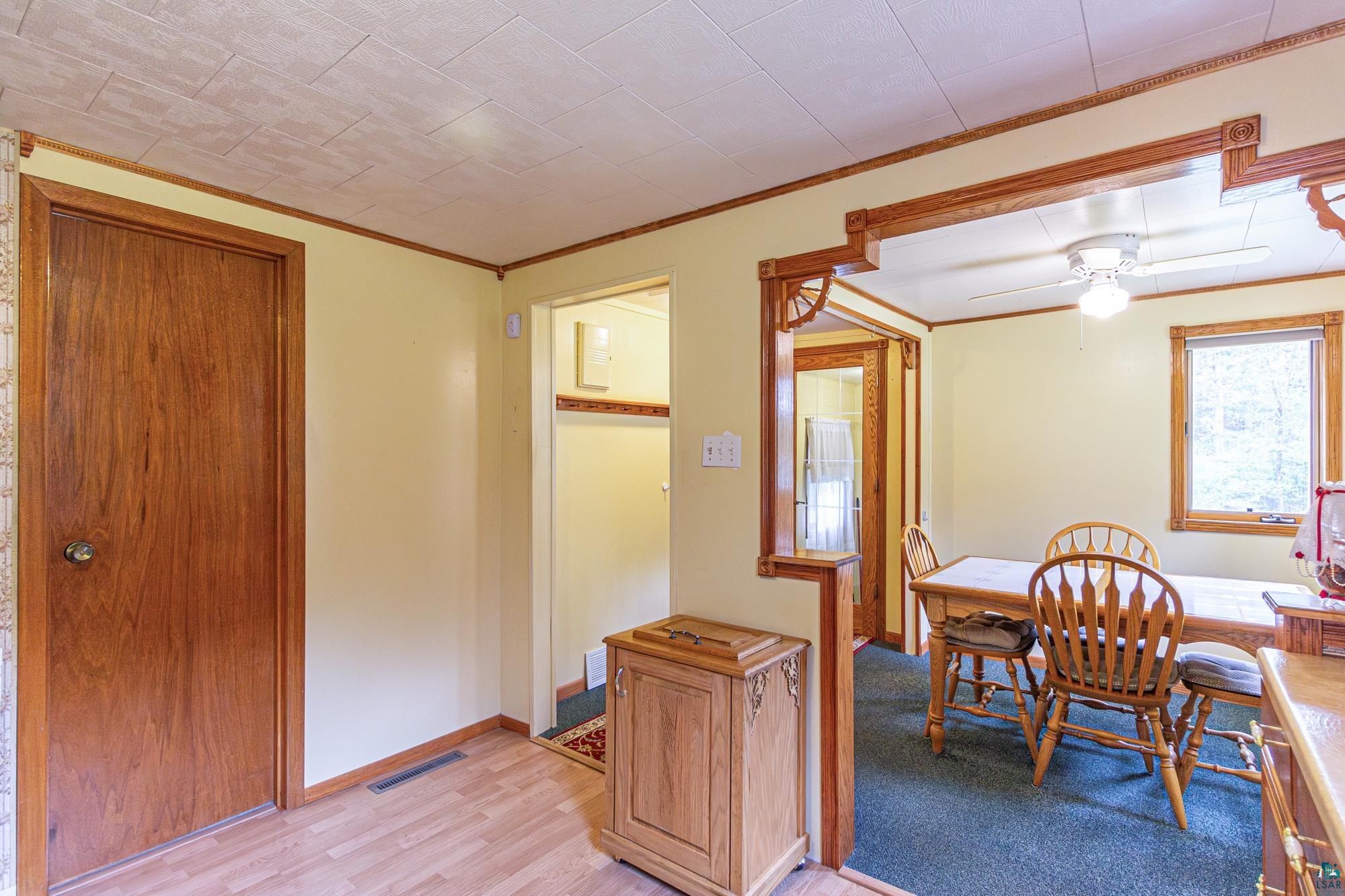 Carpeted dining space with ceiling fan