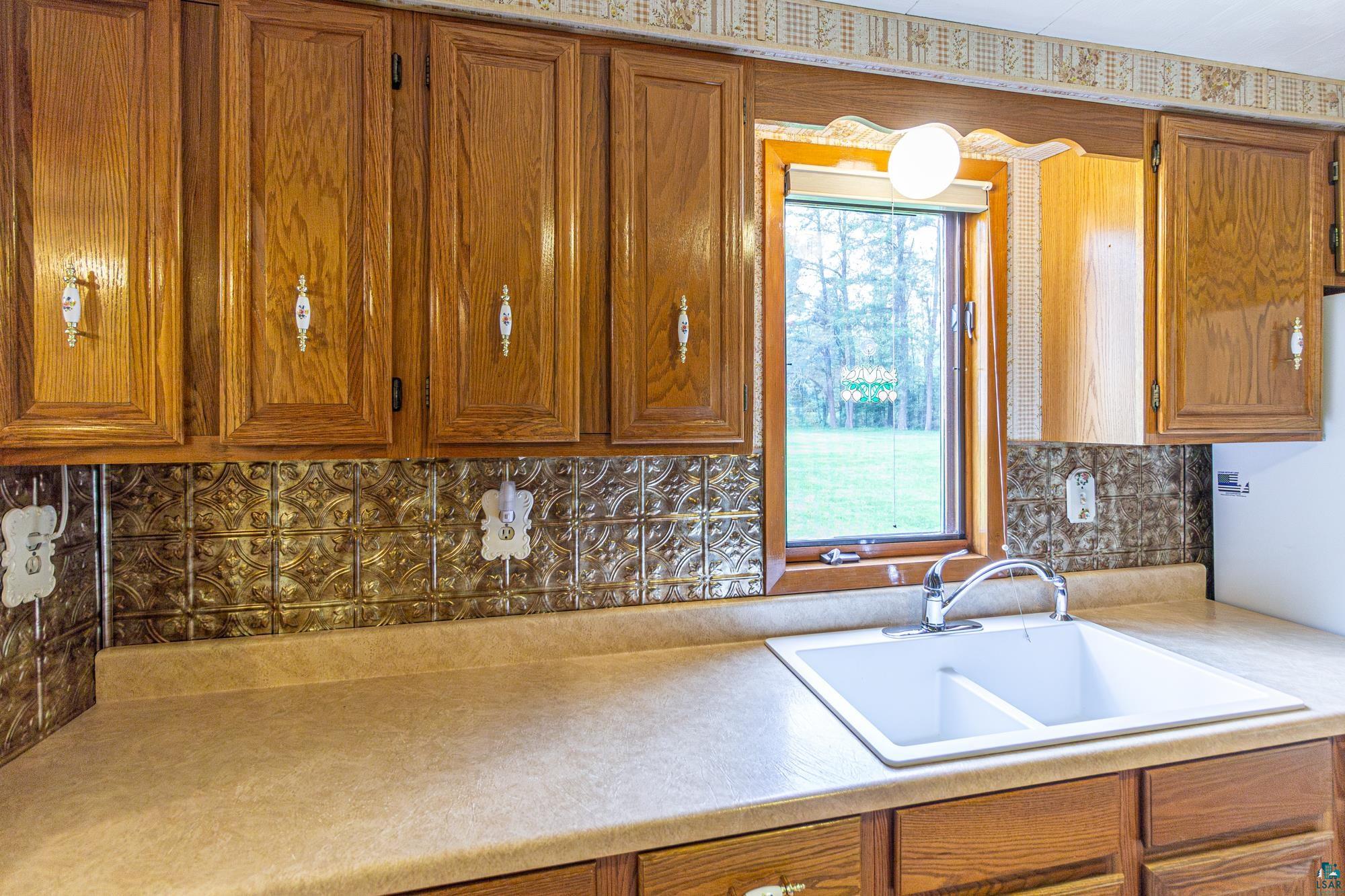 1775 Lookout Road Ely, MN 55731 - Photo 8 of 44 Kitchen featuring sink and tasteful backsplash