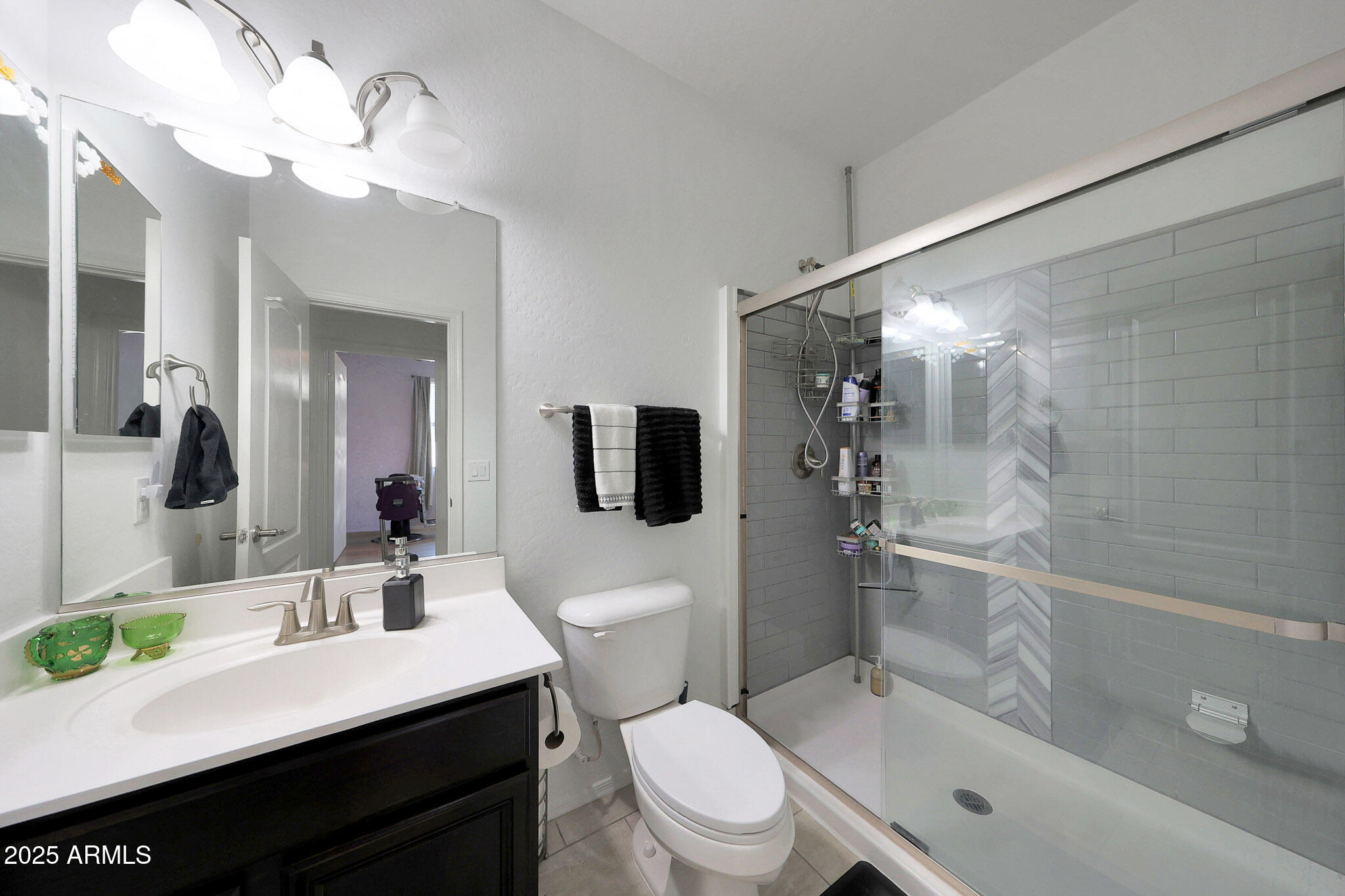 3446 North Mayfair Mesa, AZ 85213 - Photo 12 of 49 a bathroom with a sink a toilet a mirror and shower