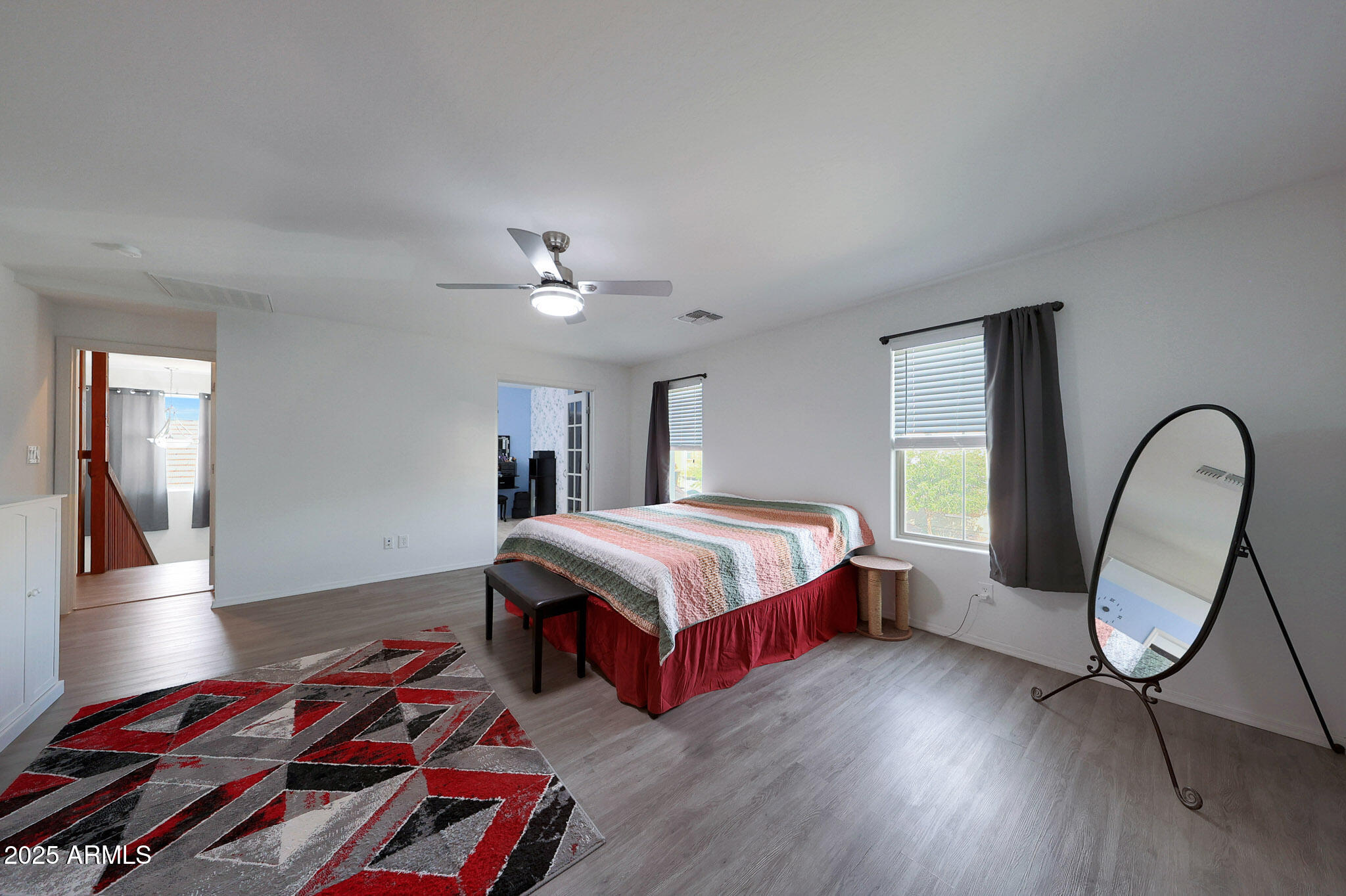 3446 North Mayfair Mesa, AZ 85213 - Photo 24 of 49 a spacious bedroom with a bed a dresser with wooden floor