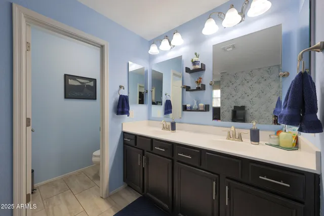 a bathroom with a sink a large mirror and a shower