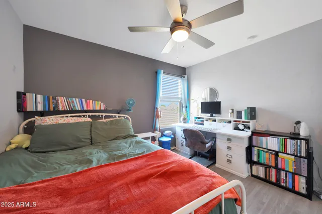 a bedroom with a bed and a book shelf
