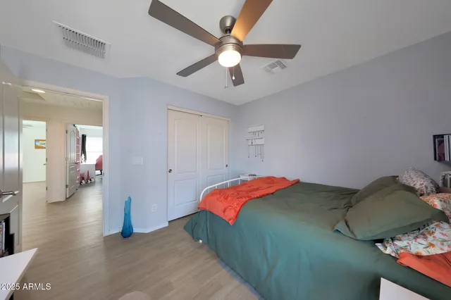 a bedroom with bed and a chandelier