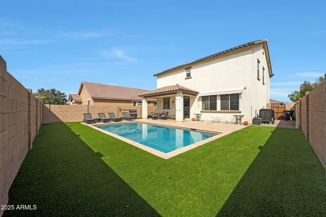 a view of house with swimming pool outdoor seating