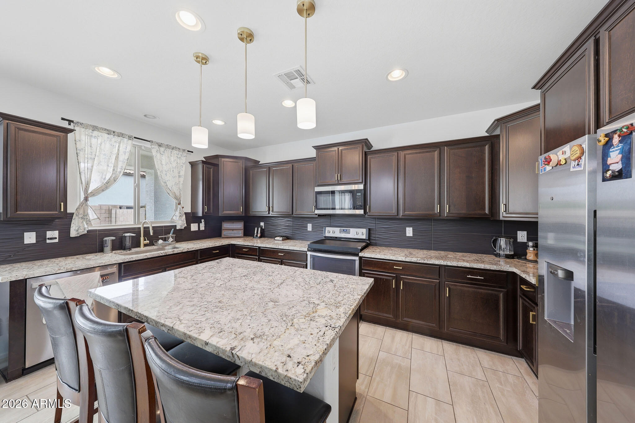 3446 North Mayfair Mesa, AZ 85213 - Photo 5 of 49 a kitchen with stainless steel appliances granite countertop a sink a stove a refrigerator and island