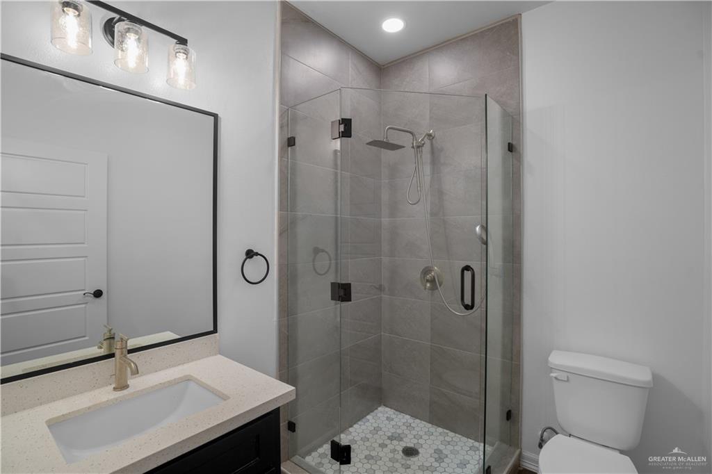 3701 South Solstice Road Edinburg, TX 78542 - Photo 14 of 17 a bathroom with a sink shower and a toilet